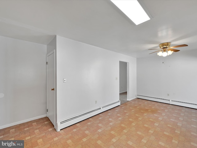 unfurnished room featuring baseboard heating, a ceiling fan, and baseboards