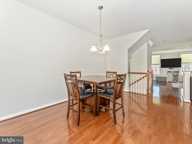 dining area featuring an inviting chandelier and light hardwood / wood-style floors