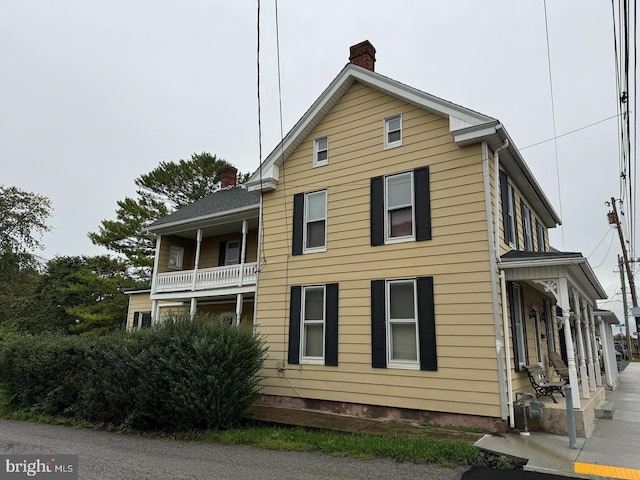 view of property exterior featuring a chimney