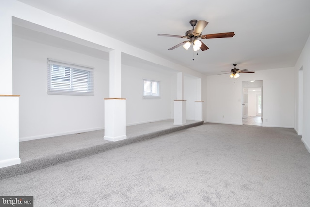 carpeted spare room with ceiling fan