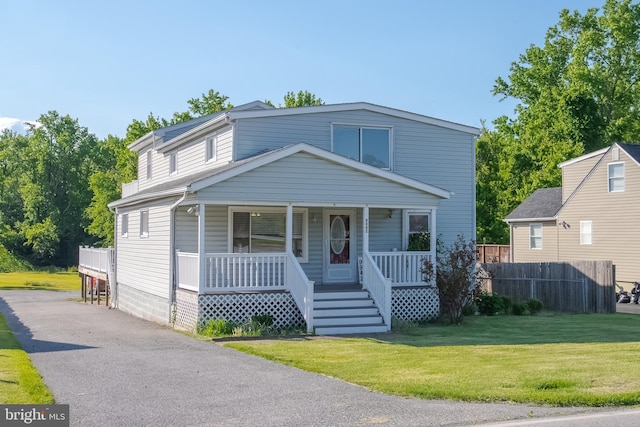 view of front of home with a front yard and covered porch