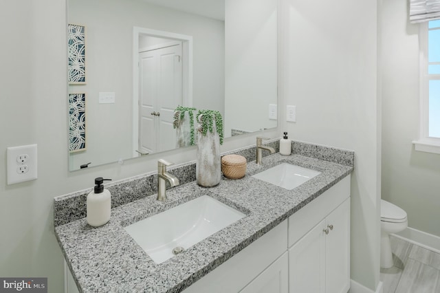 bathroom featuring vanity and toilet