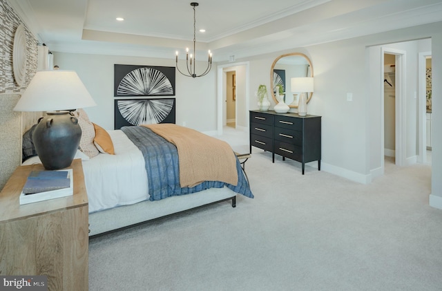 carpeted bedroom with a raised ceiling, ornamental molding, and an inviting chandelier