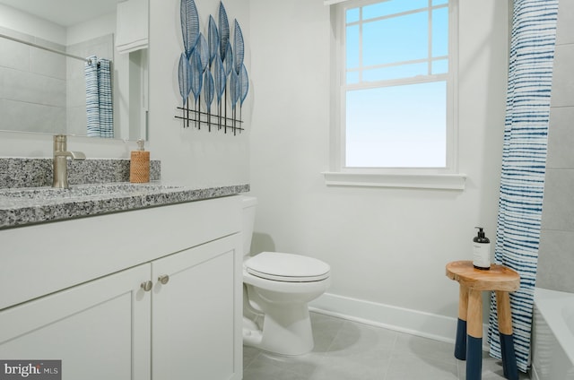 full bathroom with vanity, tile patterned flooring, toilet, and a healthy amount of sunlight