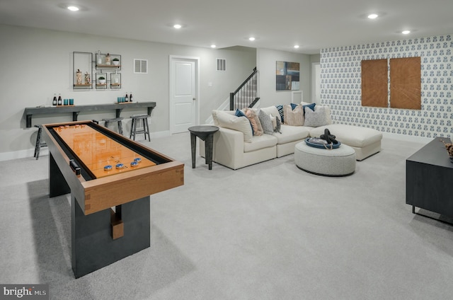 playroom featuring light carpet and bar area