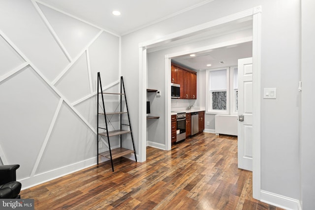 interior space with ornamental molding and dark wood-type flooring