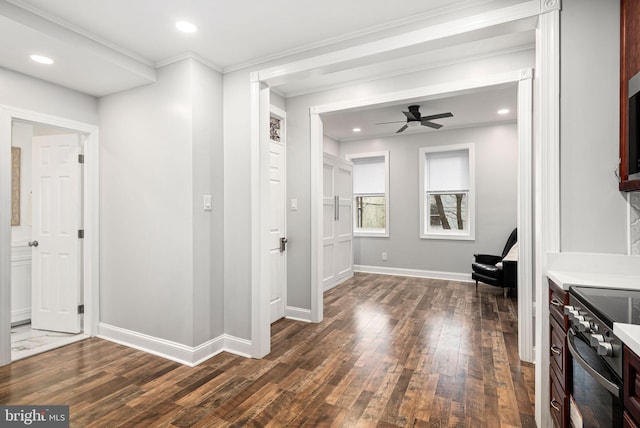 hallway with ornamental molding and dark hardwood / wood-style floors