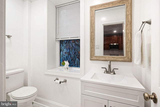 bathroom featuring vanity and toilet