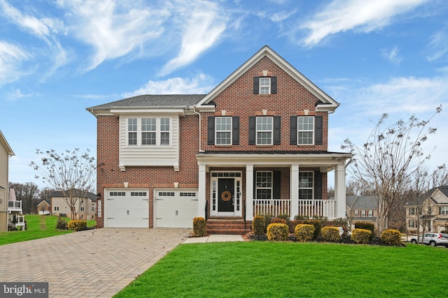 view of front facade with a front lawn, decorative driveway, and brick siding