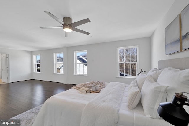 bedroom featuring dark wood finished floors, baseboards, and ceiling fan