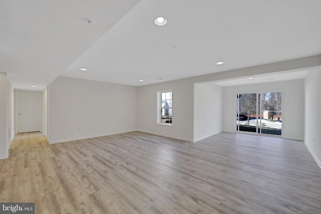 unfurnished living room featuring light wood-style floors, baseboards, and recessed lighting