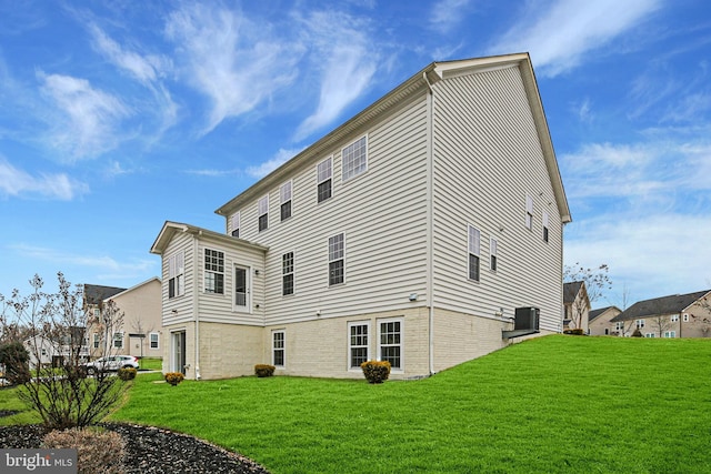 view of property exterior featuring central AC unit and a lawn