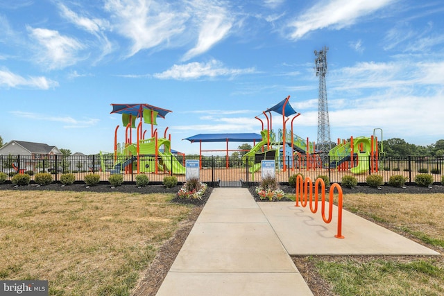 community play area with a yard and fence