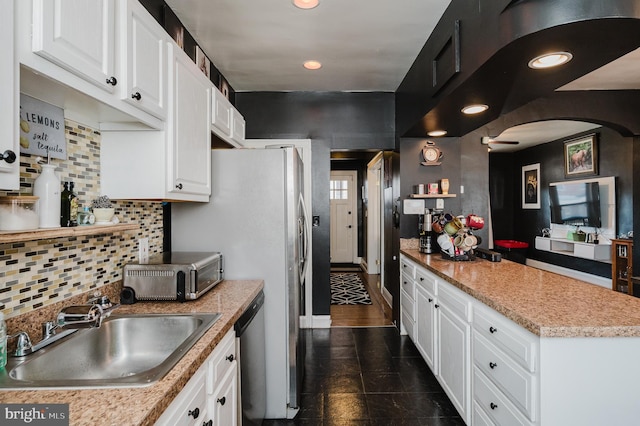 kitchen featuring light countertops, white cabinets, a sink, and visible vents