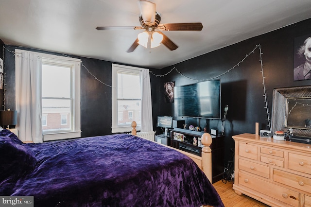 bedroom with light wood-type flooring and a ceiling fan