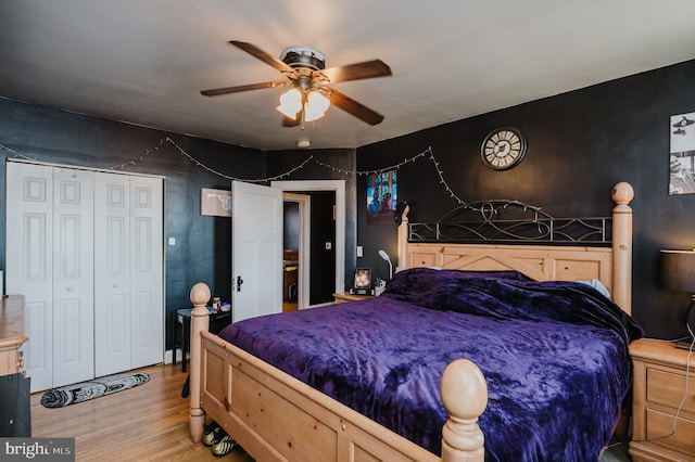 bedroom with a ceiling fan, a closet, and light wood-style flooring