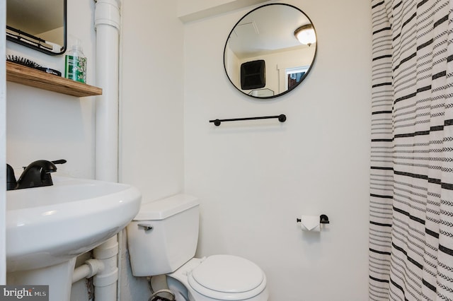 bathroom featuring toilet and a sink