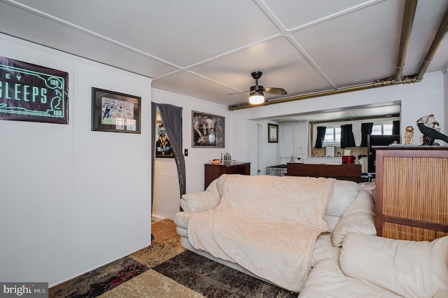 living area with a ceiling fan