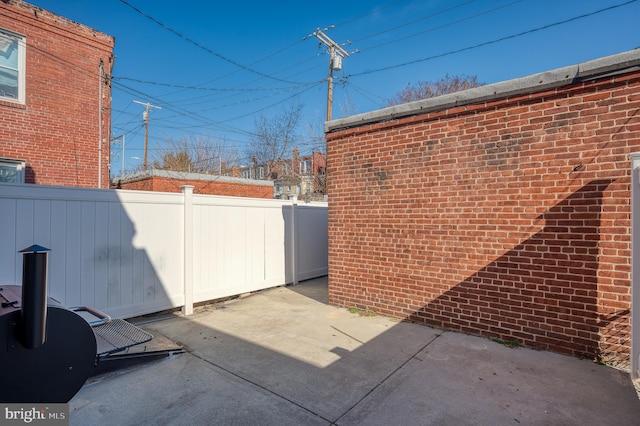 view of patio / terrace featuring fence