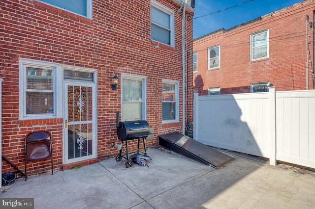 view of patio featuring fence and grilling area