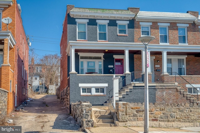 townhome / multi-family property featuring brick siding