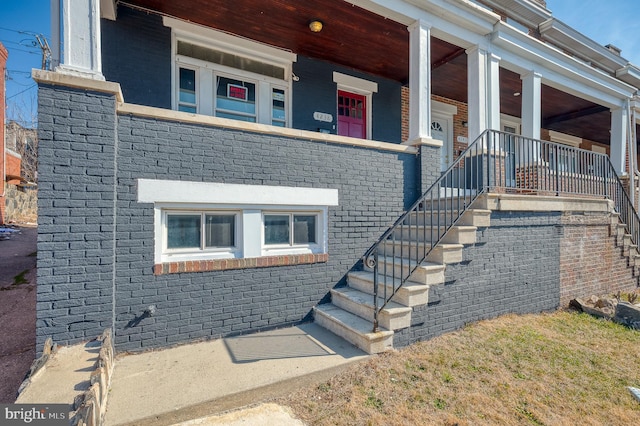 doorway to property featuring brick siding