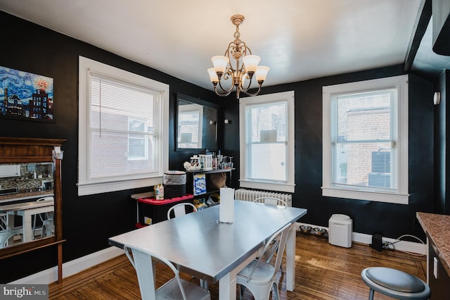 dining room with baseboards, radiator heating unit, a chandelier, and dark wood-style flooring