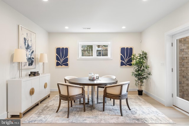 dining area with baseboards, visible vents, light wood-style flooring, and recessed lighting