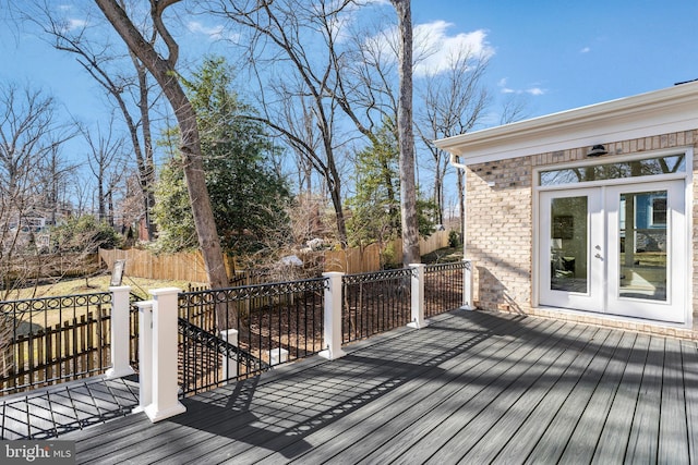 wooden terrace featuring french doors and fence