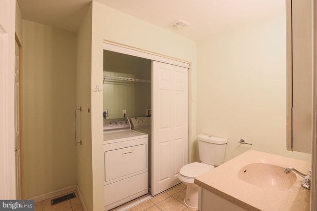 bathroom featuring vanity, tile patterned floors, and toilet