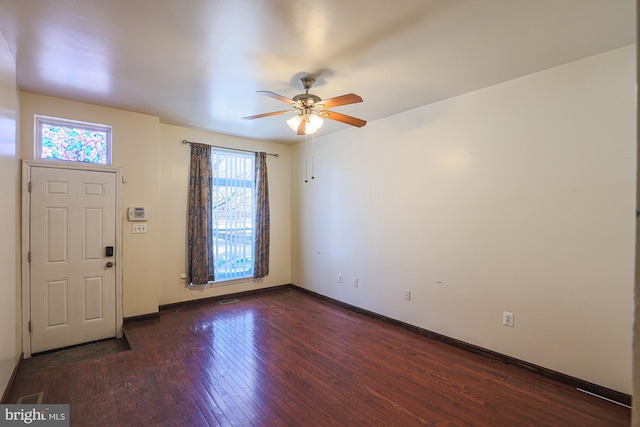 foyer with dark wood-type flooring, ceiling fan, and a wealth of natural light