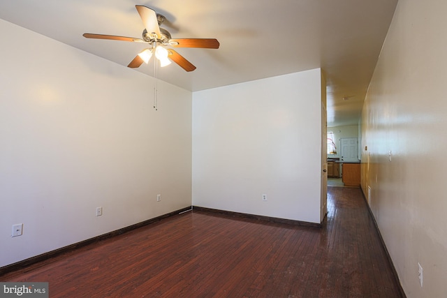 spare room featuring dark hardwood / wood-style flooring and ceiling fan