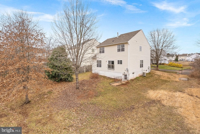 rear view of property with a lawn and central air condition unit