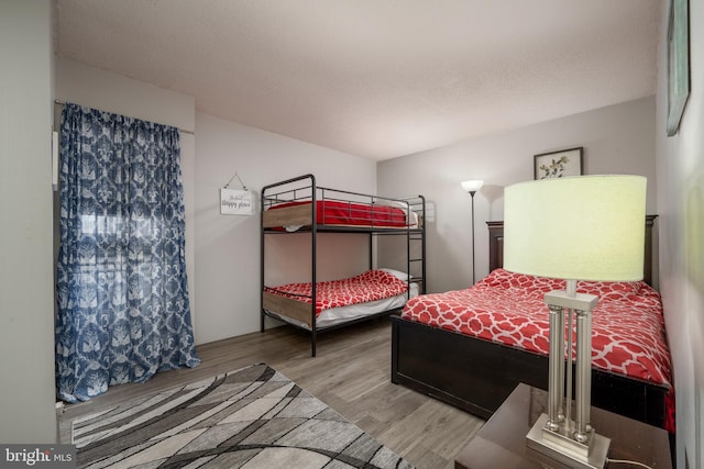 bedroom featuring wood-type flooring and a textured ceiling