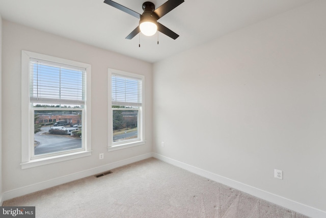 carpeted empty room featuring ceiling fan