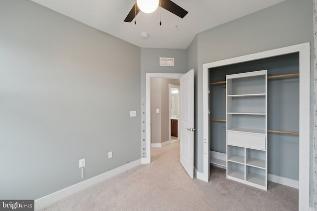 unfurnished bedroom with light carpet, ceiling fan, and a closet