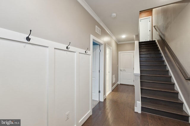 stairs with hardwood / wood-style flooring and ornamental molding