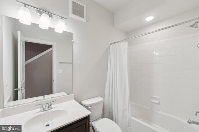 full bathroom with vanity, toilet, and shower / bath combo with shower curtain