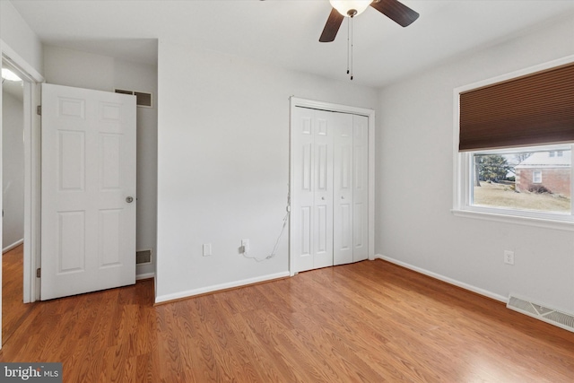 unfurnished bedroom with light wood finished floors, visible vents, and baseboards