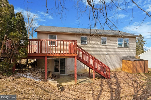 back of house with stairs, a patio, and a wooden deck