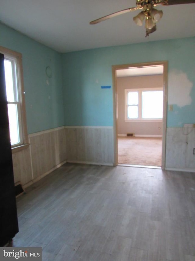 spare room with ceiling fan and wood-type flooring