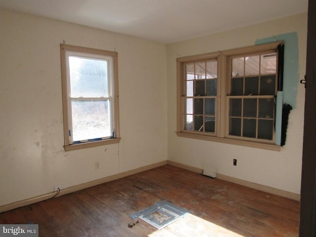 empty room with dark hardwood / wood-style floors