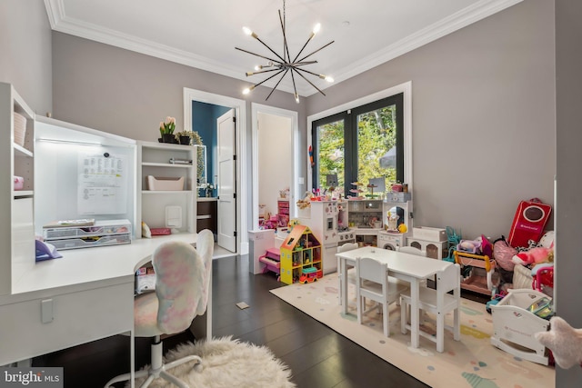 playroom featuring dark hardwood / wood-style flooring, a notable chandelier, and ornamental molding