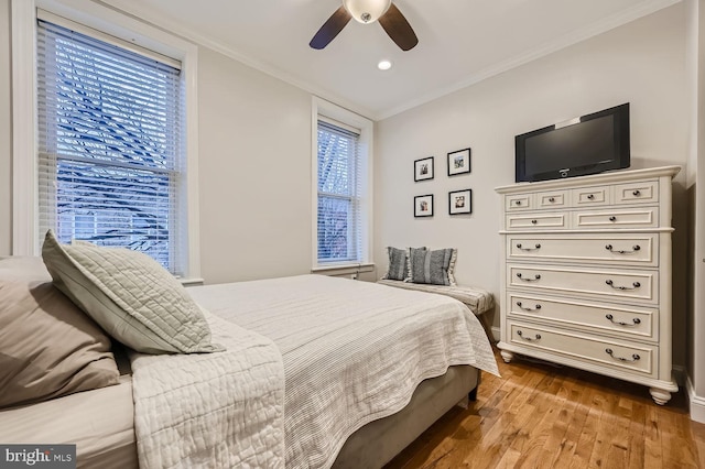 bedroom featuring ornamental molding, hardwood / wood-style floors, and ceiling fan