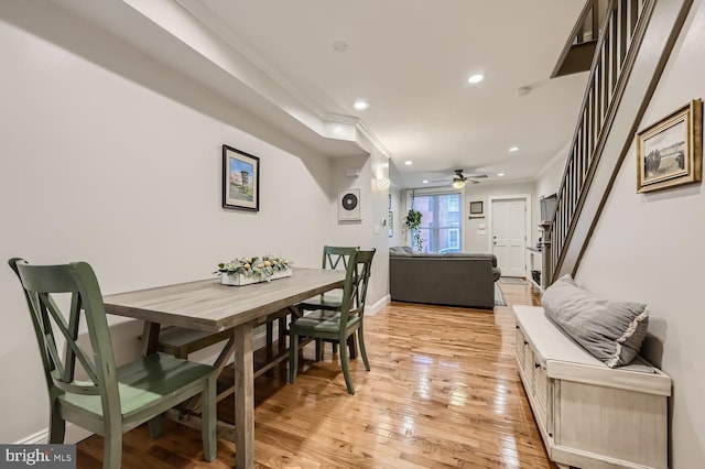 dining room with crown molding, light hardwood / wood-style floors, and ceiling fan