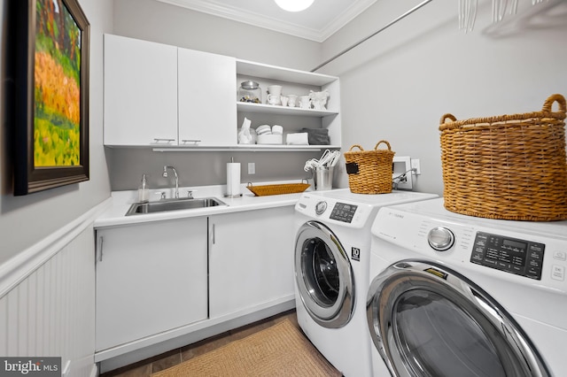 laundry room with separate washer and dryer, a sink, wainscoting, cabinet space, and crown molding