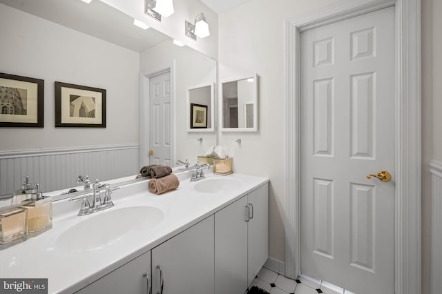 full bathroom with double vanity and a sink