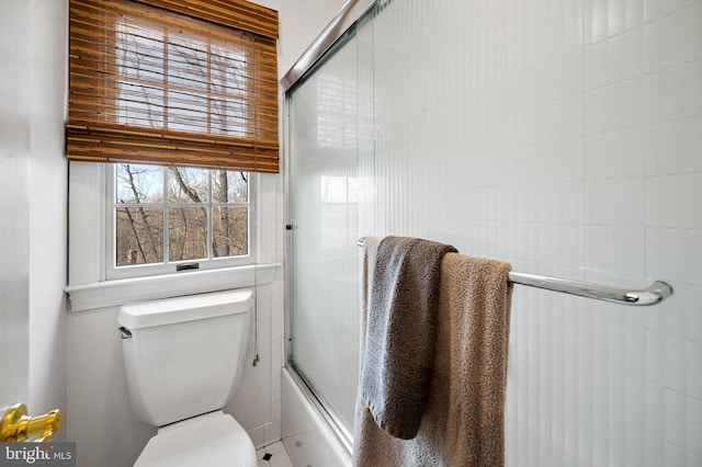 full bathroom with shower / bath combination with glass door and toilet