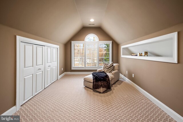 sitting room featuring lofted ceiling, carpet floors, and baseboards