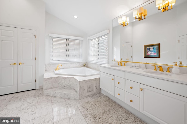 full bath featuring marble finish floor, double vanity, lofted ceiling, a sink, and a bath